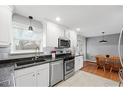 a kitchen with stainless steel appliances kitchen island granite countertop a sink and cabinets