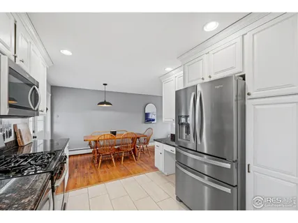 a kitchen with stainless steel appliances kitchen island granite countertop a sink and cabinets