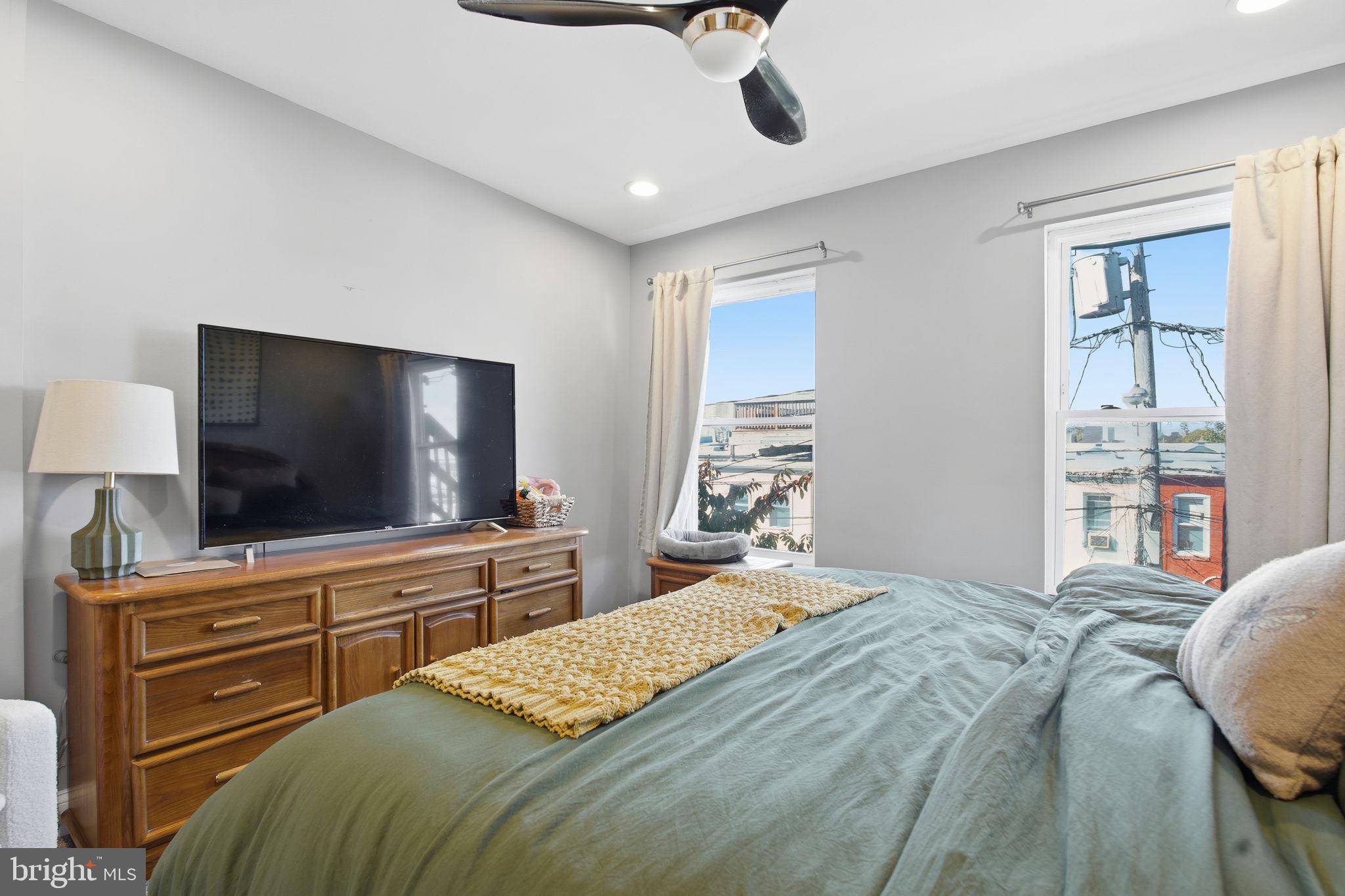 236 South Clinton Street Baltimore, MD 21224 - Photo 14 of 34 a bedroom with a bed and a flat screen tv