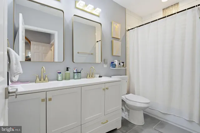 a bathroom with a sink toilet and mirror