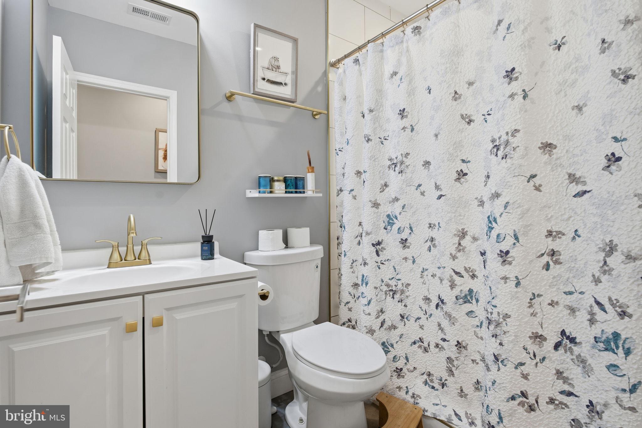 236 South Clinton Street Baltimore, MD 21224 - Photo 19 of 34 a bathroom with a sink toilet and mirror