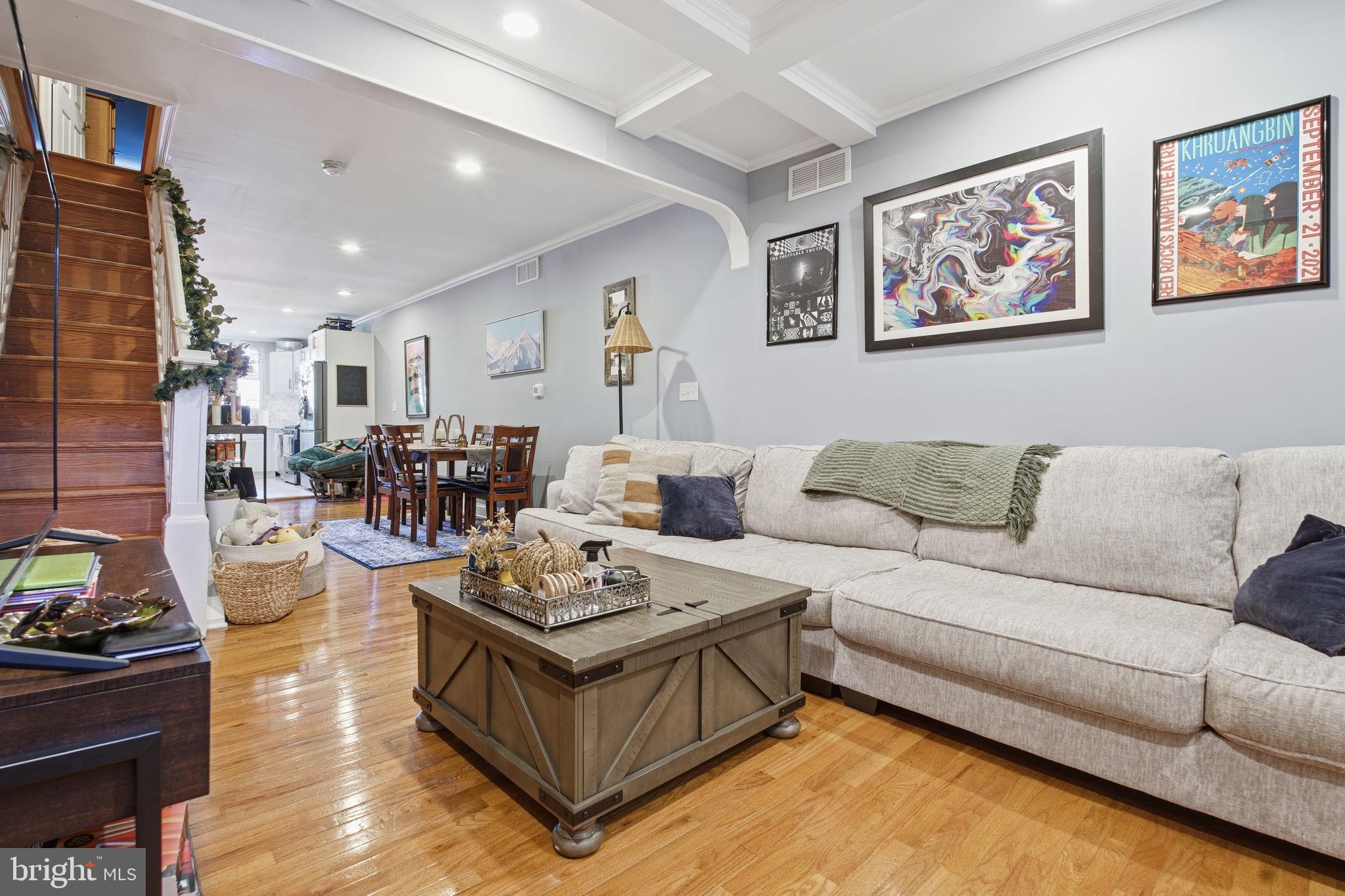 236 South Clinton Street Baltimore, MD 21224 - Photo 2 of 34 a living room with furniture a rug kitchen view and a window