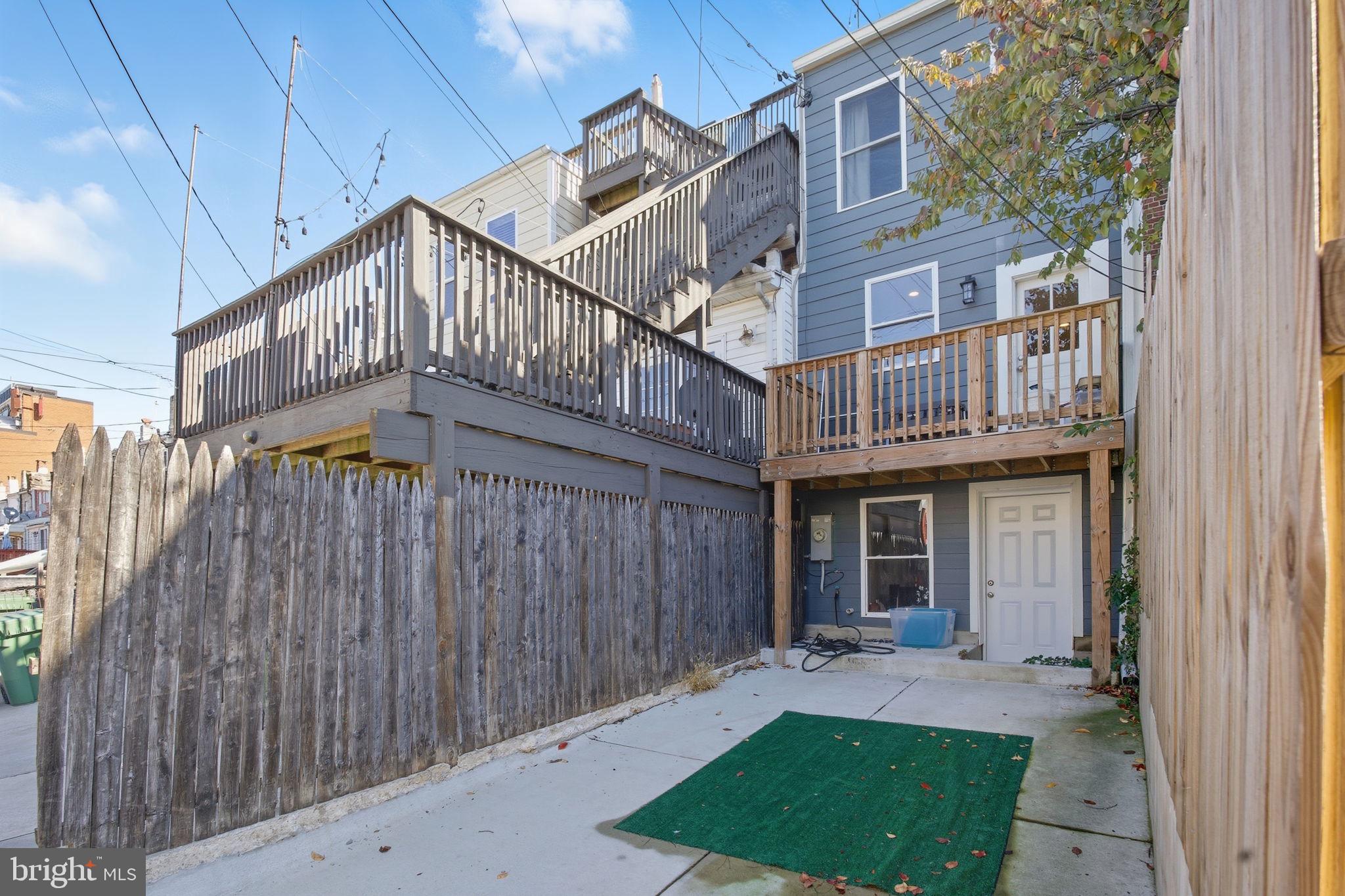 236 South Clinton Street Baltimore, MD 21224 - Photo 31 of 34 a view of a house with a yard and wooden fence