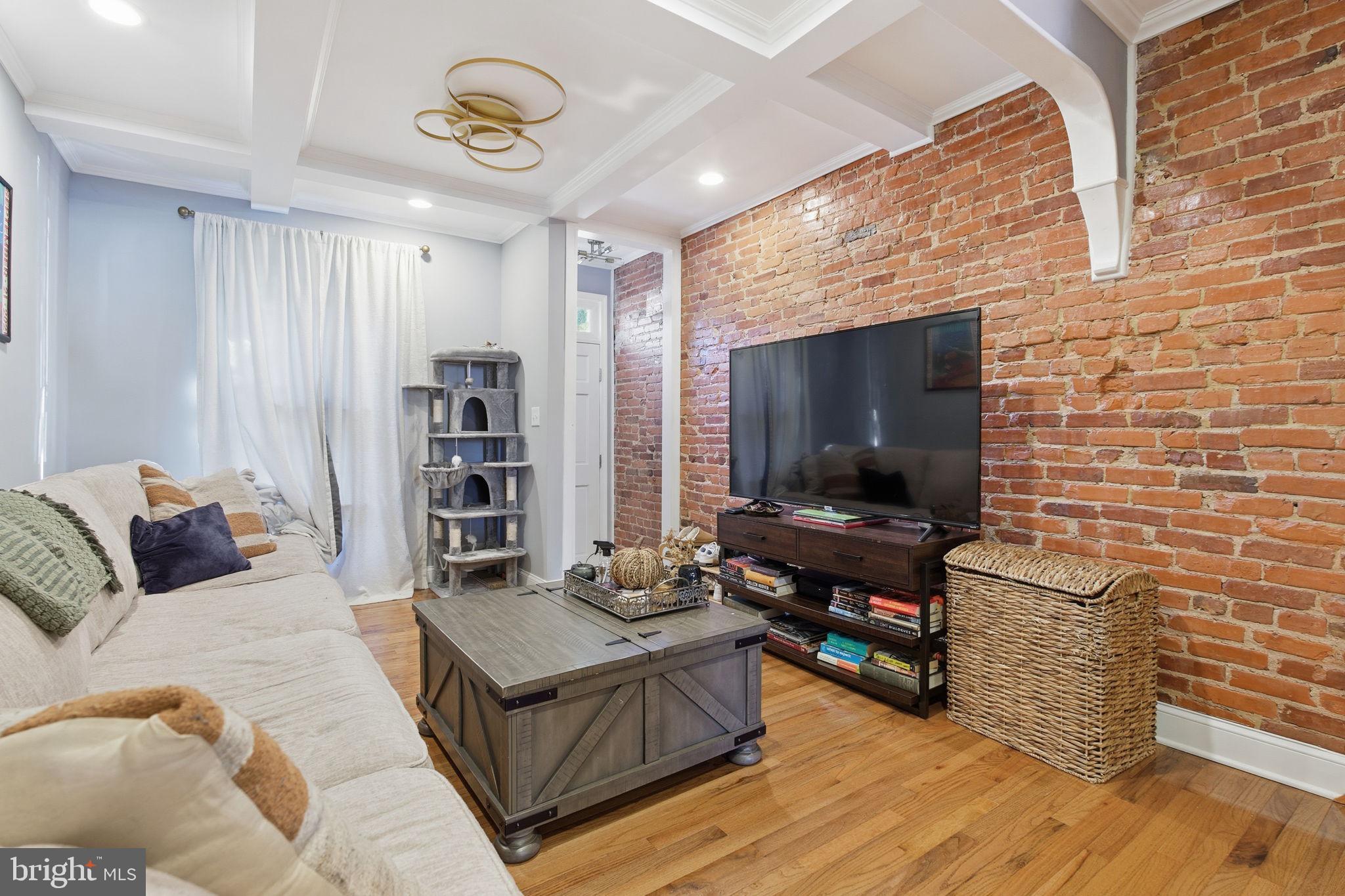 236 South Clinton Street Baltimore, MD 21224 - Photo 4 of 34 a living room with furniture and a flat screen tv