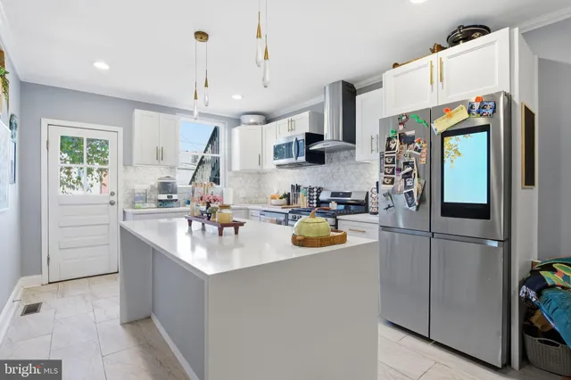 a view of a kitchen with stainless steel appliances granite countertop a stove and a sink
