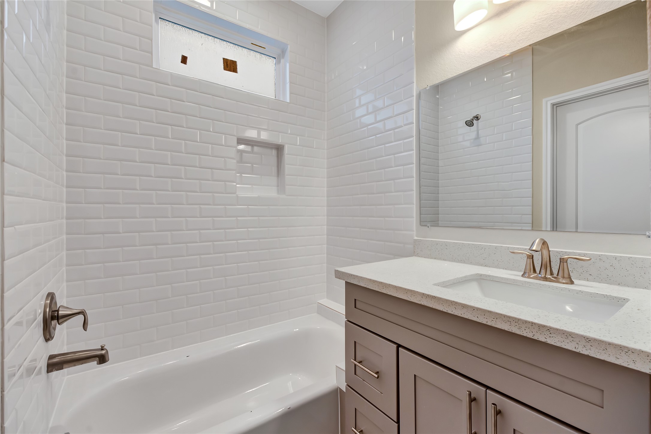 21 Latham Street, Unit D Houston, TX 77011 - Photo 5 of 8 a bathroom with a sink a bathtub and a shower