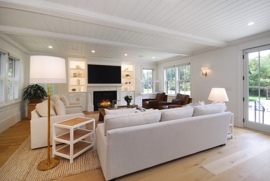 11 Williams Road Concord, MA 01742 - Photo 16 of 42 a living room with furniture a flat screen tv and a fireplace