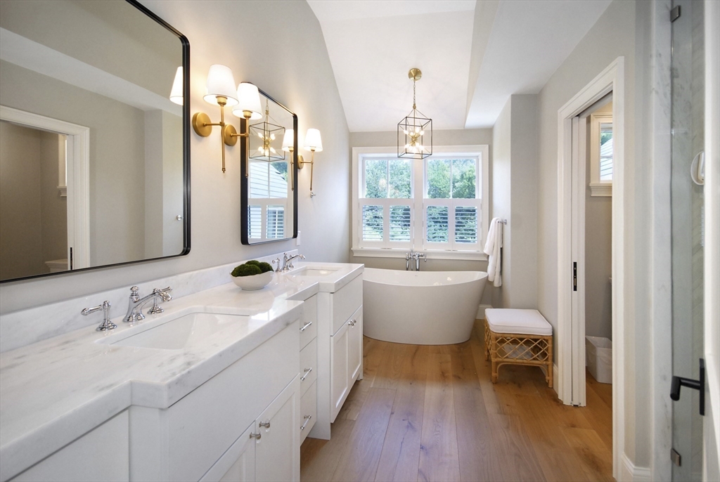 11 Williams Road Concord, MA 01742 - Photo 22 of 42 a spacious bathroom with a granite countertop sink mirror and a bathtub