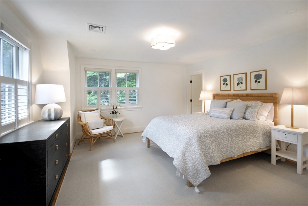 11 Williams Road Concord, MA 01742 - Photo 23 of 42 a spacious bedroom with a bed and a large window