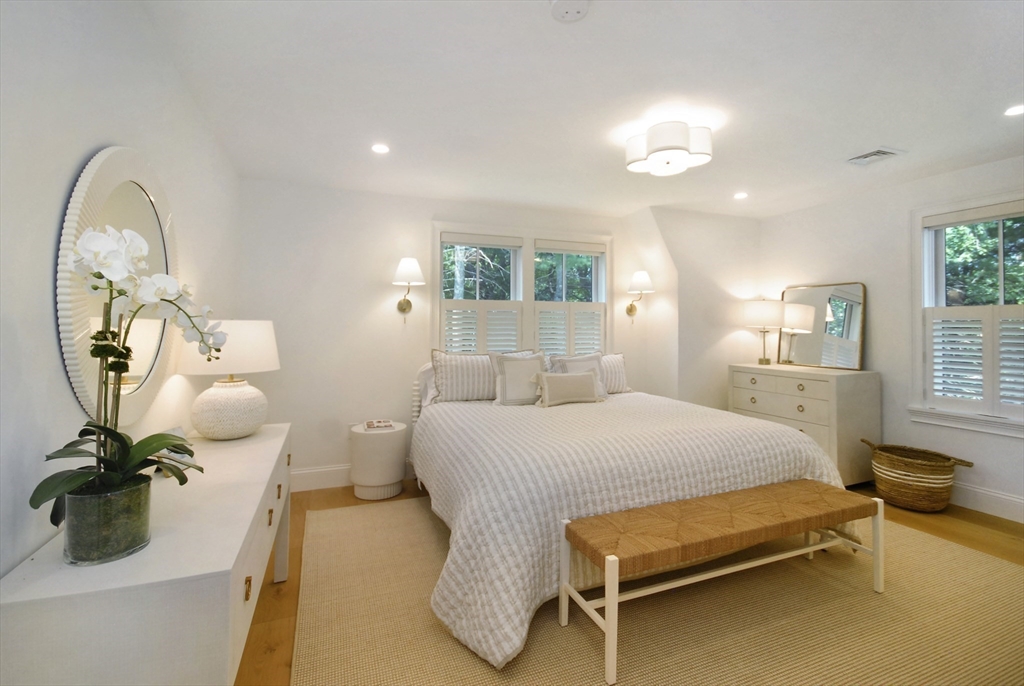 11 Williams Road Concord, MA 01742 - Photo 24 of 42 a spacious bedroom with a bed and a chandelier