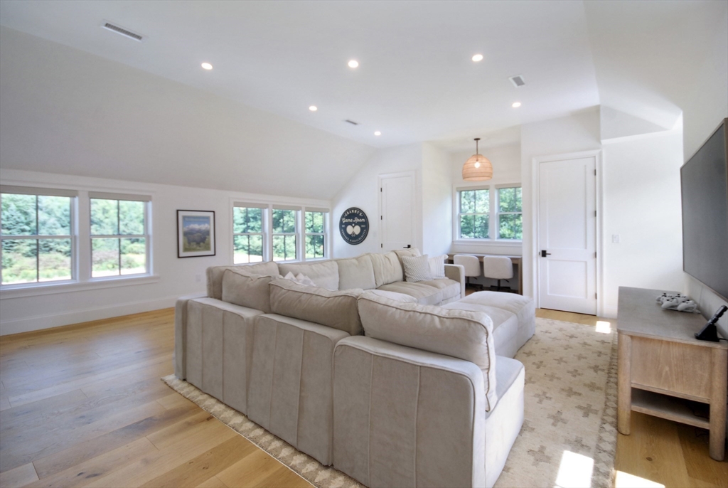 11 Williams Road Concord, MA 01742 - Photo 27 of 42 a living room with furniture and a flat screen tv
