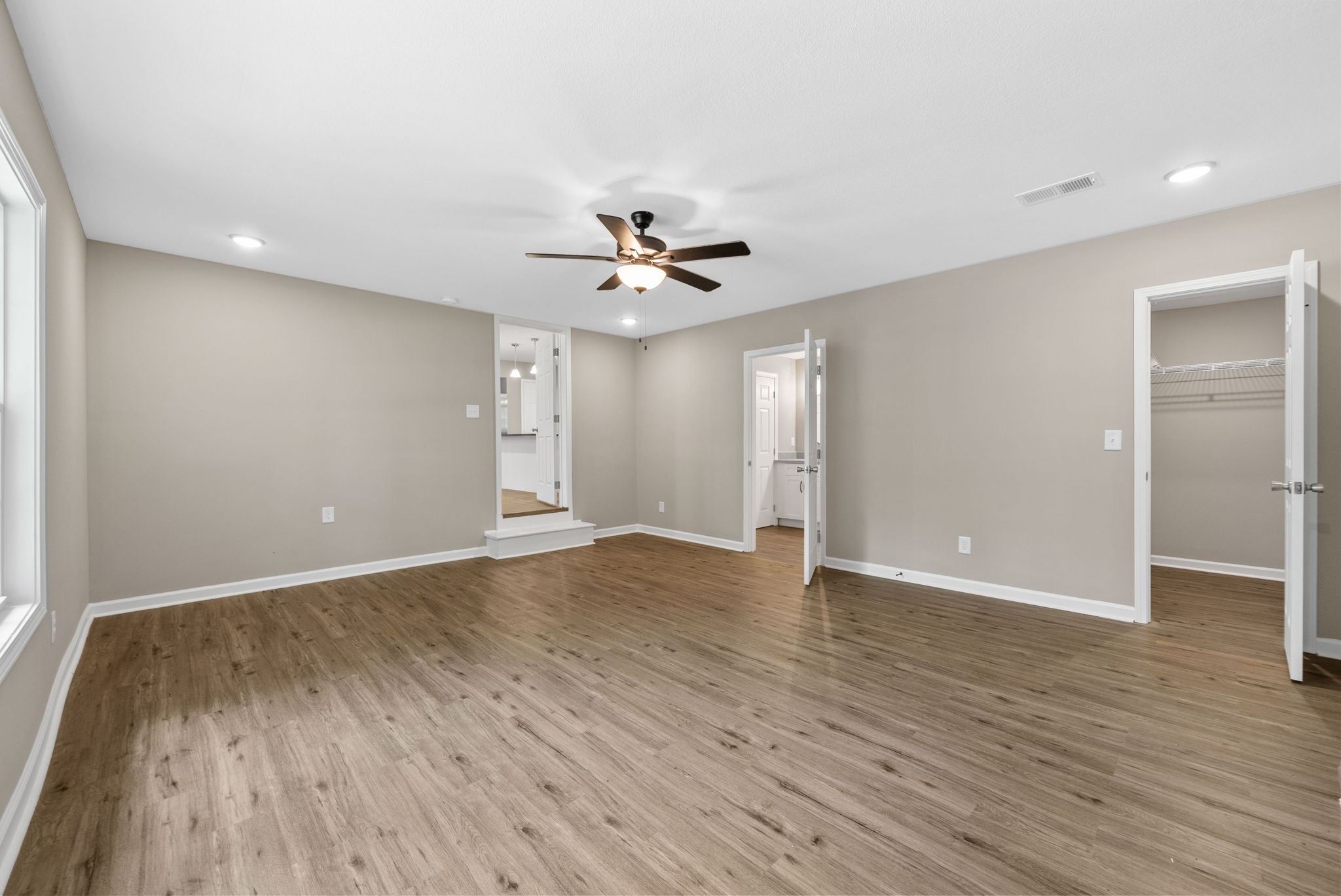 138 Walker Ridge Road Big Rock, TN 37023 - Photo 16 of 42 an empty room with wooden floor and a ceiling fan