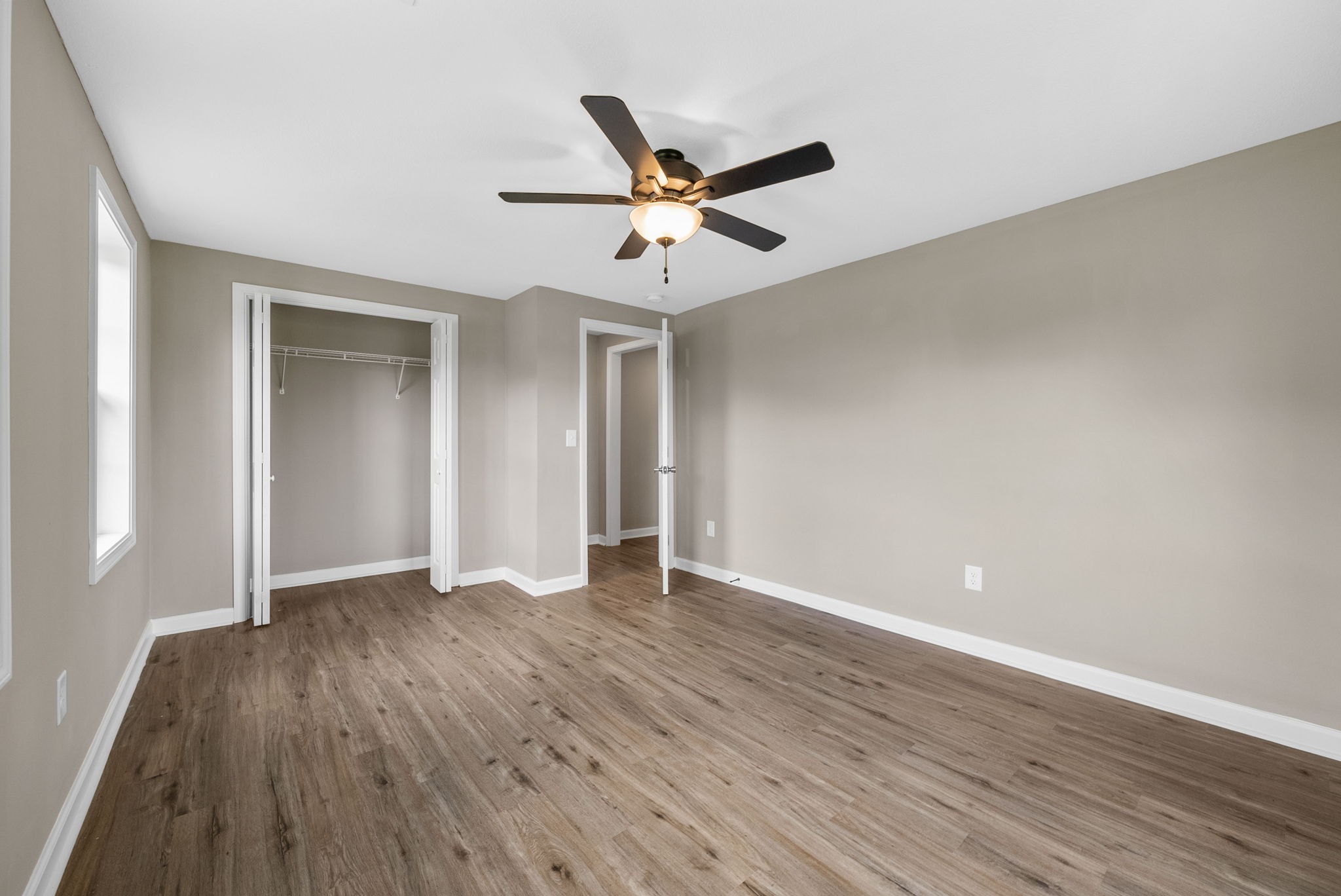 138 Walker Ridge Road Big Rock, TN 37023 - Photo 26 of 42 an empty room with wooden floor ceiling fan and window