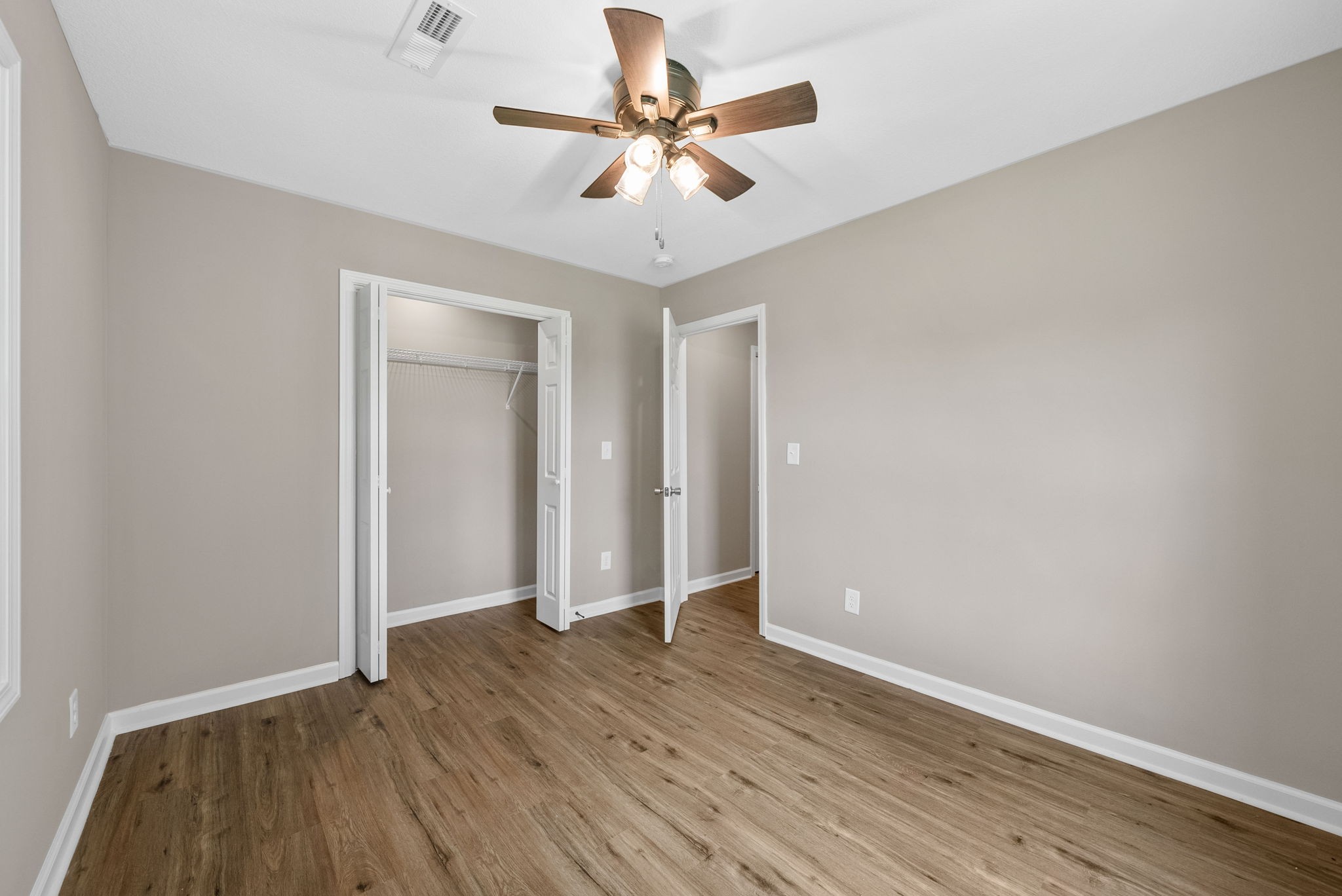 138 Walker Ridge Road Big Rock, TN 37023 - Photo 28 of 42 an empty room with wooden floor and ceiling fan