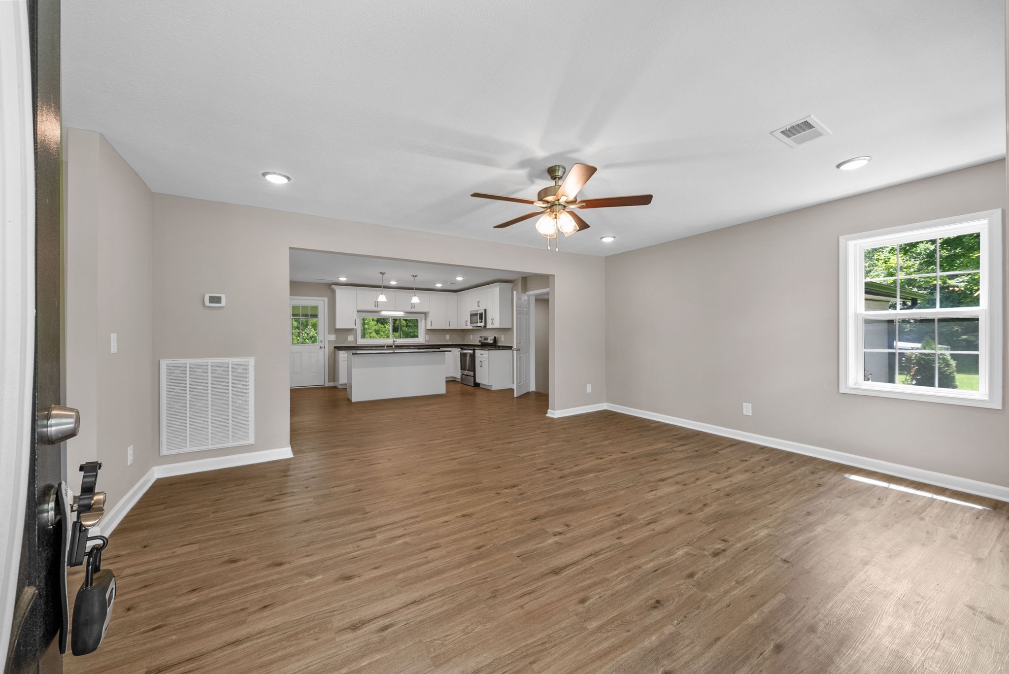 138 Walker Ridge Road Big Rock, TN 37023 - Photo 3 of 42 a view of an empty room with a window and wooden floor
