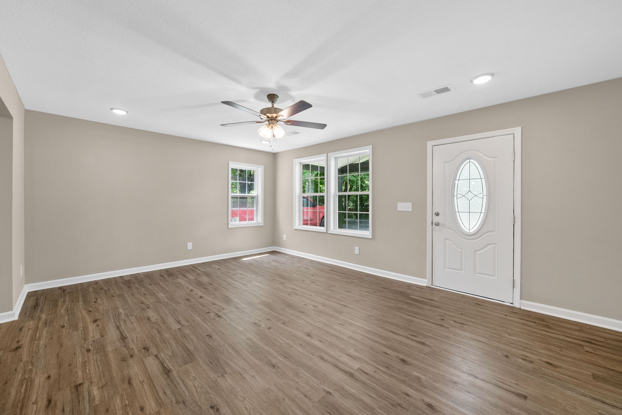 138 Walker Ridge Road Big Rock, TN 37023 - Photo 4 of 42 an empty room with wooden floor and windows