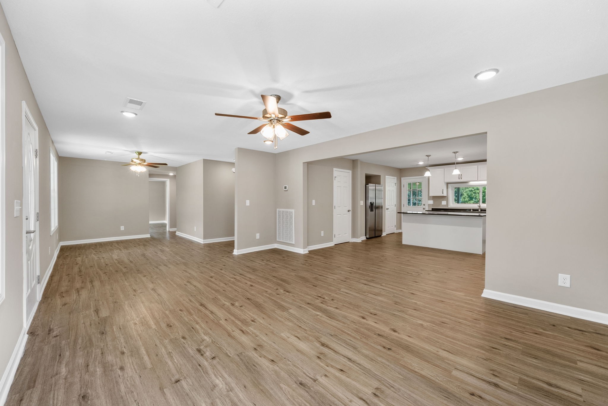 138 Walker Ridge Road Big Rock, TN 37023 - Photo 6 of 42 a view of an empty room with wooden floor and a kitchen