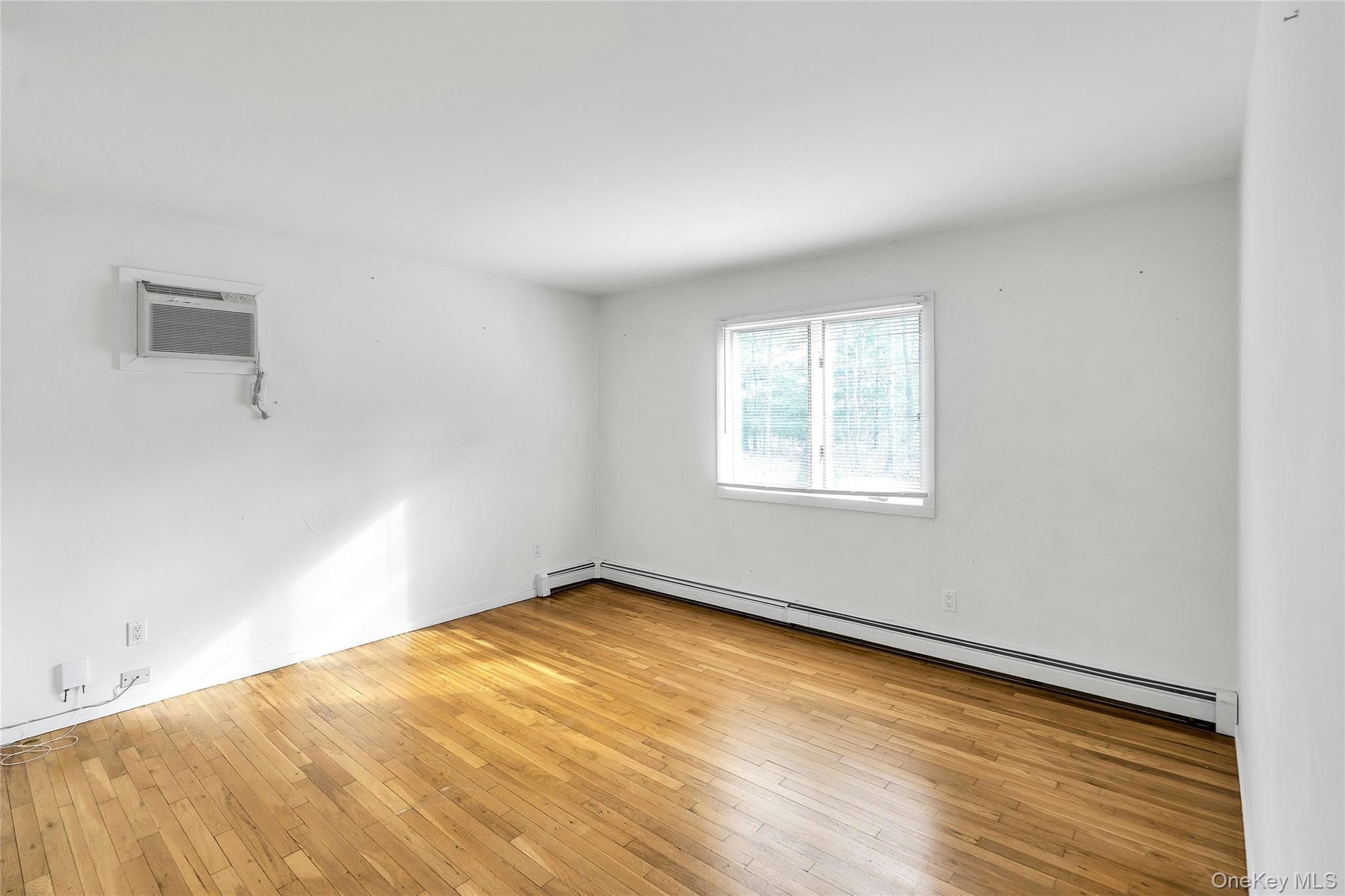 23 Bellows Terrace Hampton Bays, NY 11946 - Photo 11 of 31 an empty room with a window