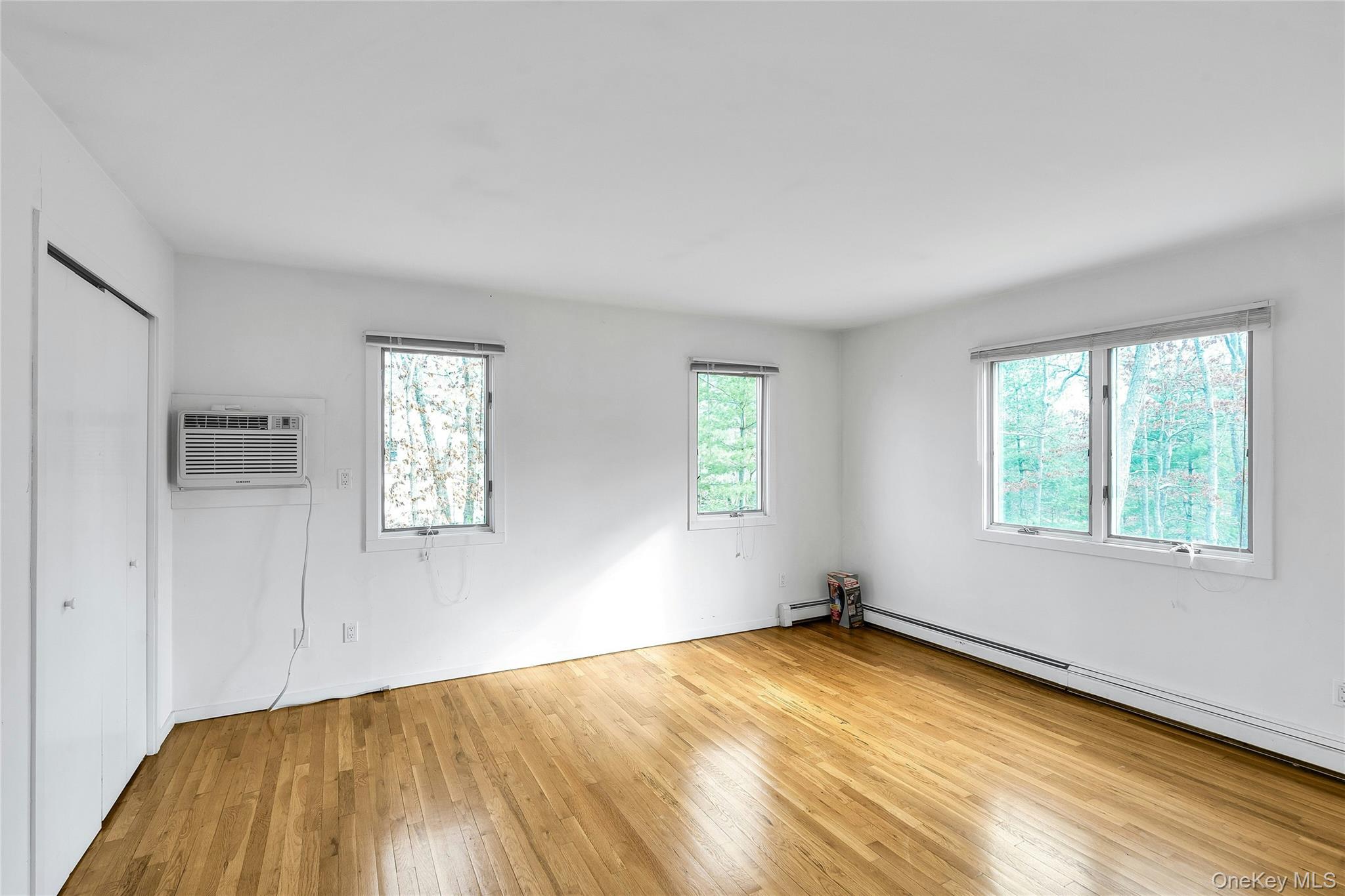 23 Bellows Terrace Hampton Bays, NY 11946 - Photo 14 of 31 a view of empty room with wooden floor and fan
