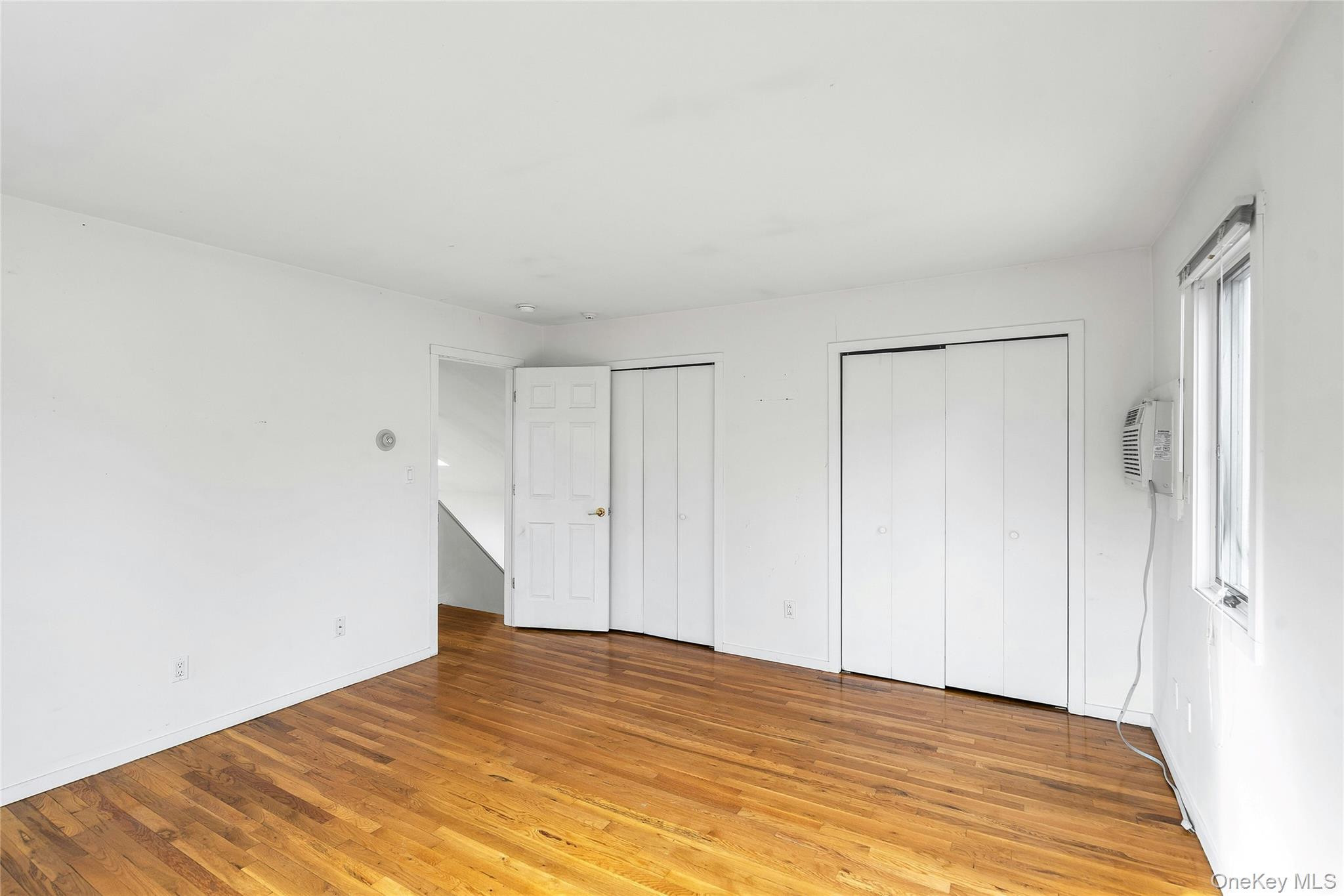 23 Bellows Terrace Hampton Bays, NY 11946 - Photo 15 of 31 a view of empty room with wooden floor