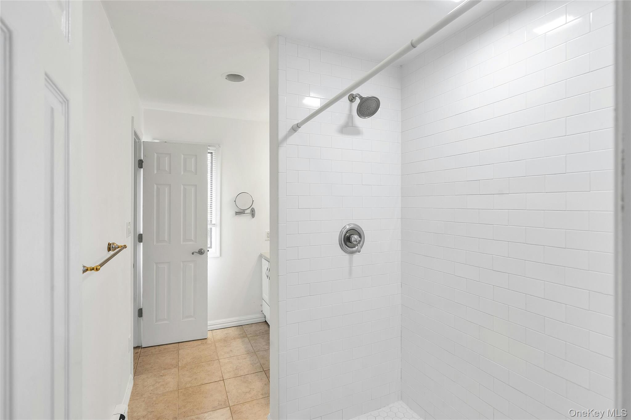 23 Bellows Terrace Hampton Bays, NY 11946 - Photo 16 of 31 a bathroom with a shower and a glass door