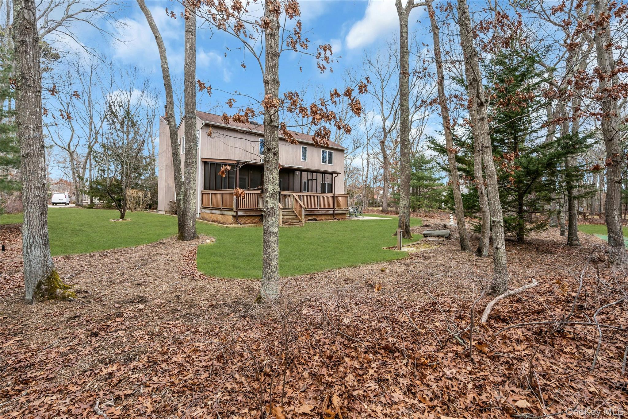 23 Bellows Terrace Hampton Bays, NY 11946 - Photo 30 of 31 a view of a house with a yard