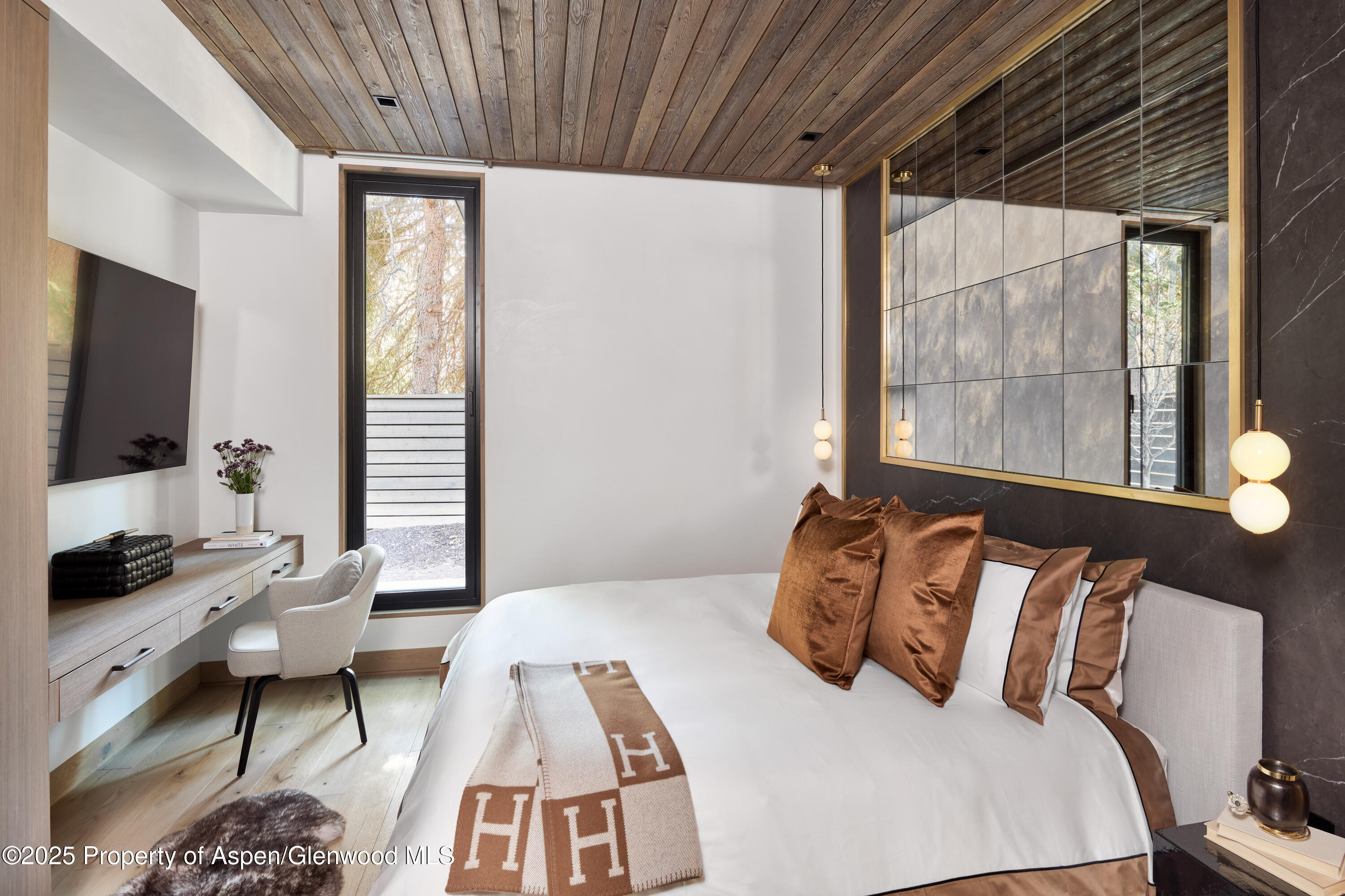 411 Pearl Court Aspen, CO 81611 - Photo 14 of 45 a bedroom with a bed and glass window