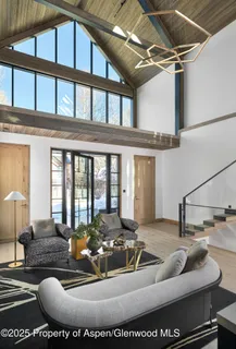 a living room with furniture fireplace and windows