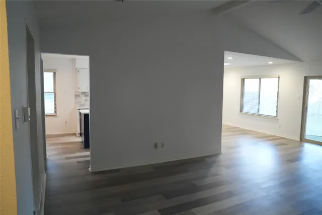 wooden floor in an empty room with a fireplace