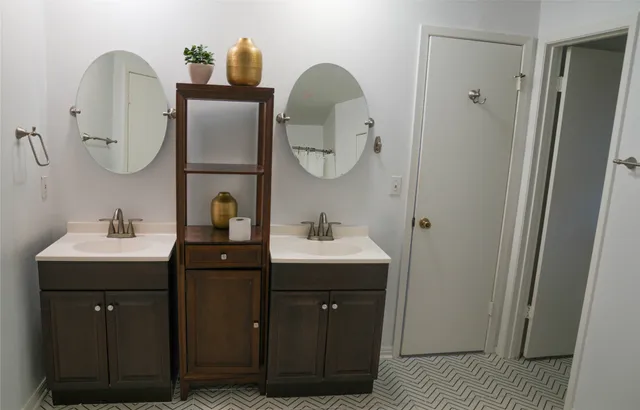 a bathroom with a double vanity sink and mirror