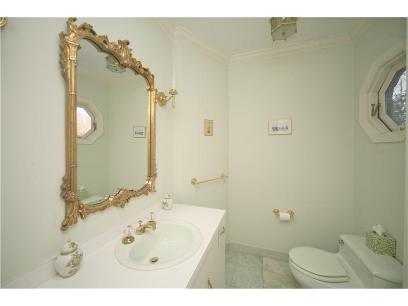 4 Locust Hill Road Darien, CT 06820 - Photo 13 of 25 a bathroom with a sink and mirror with toilet