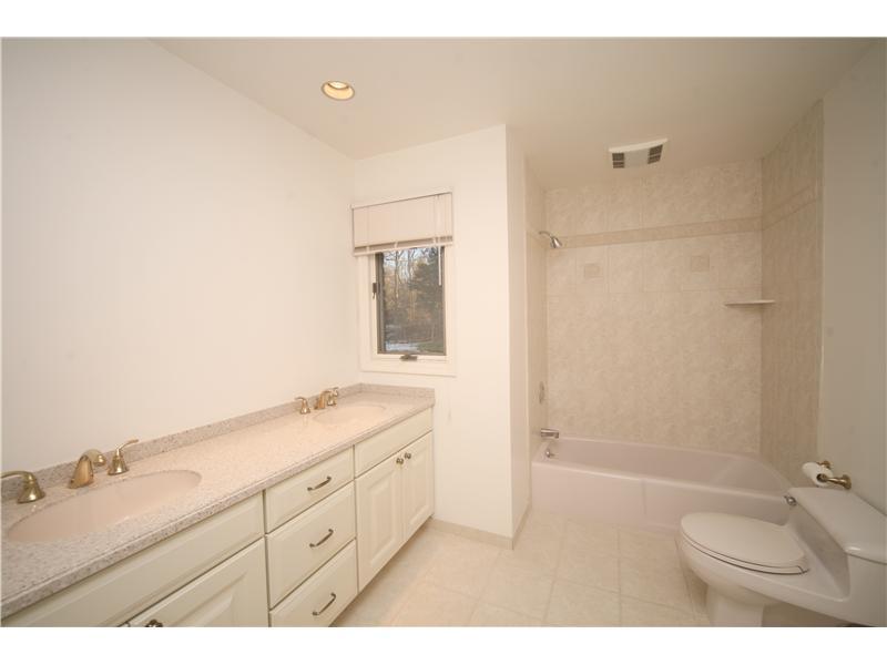 4 Locust Hill Road Darien, CT 06820 - Photo 21 of 25 a bathroom with a granite countertop sink mirror and double