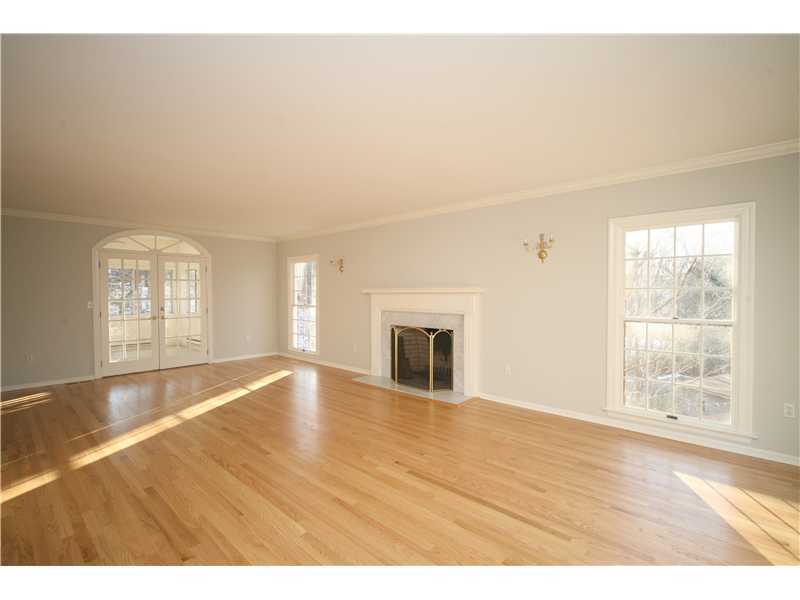 4 Locust Hill Road Darien, CT 06820 - Photo 4 of 25 an empty room with wooden floor and windows