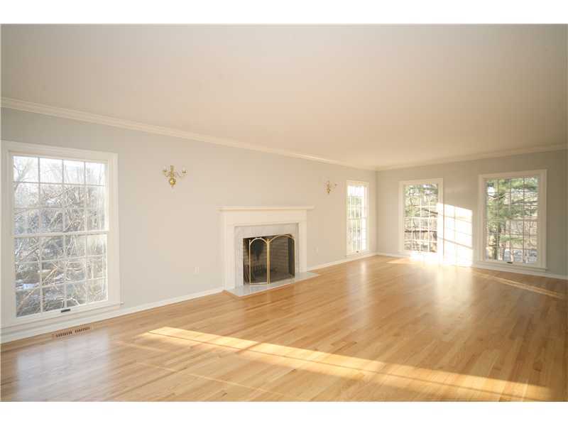 4 Locust Hill Road Darien, CT 06820 - Photo 5 of 25 a view of an empty room with wooden floor and a window