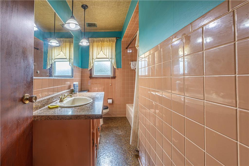 82 East Kerr Street Uniontown, PA 15401 - Photo 14 of 18 a bathroom with a sink and a mirror