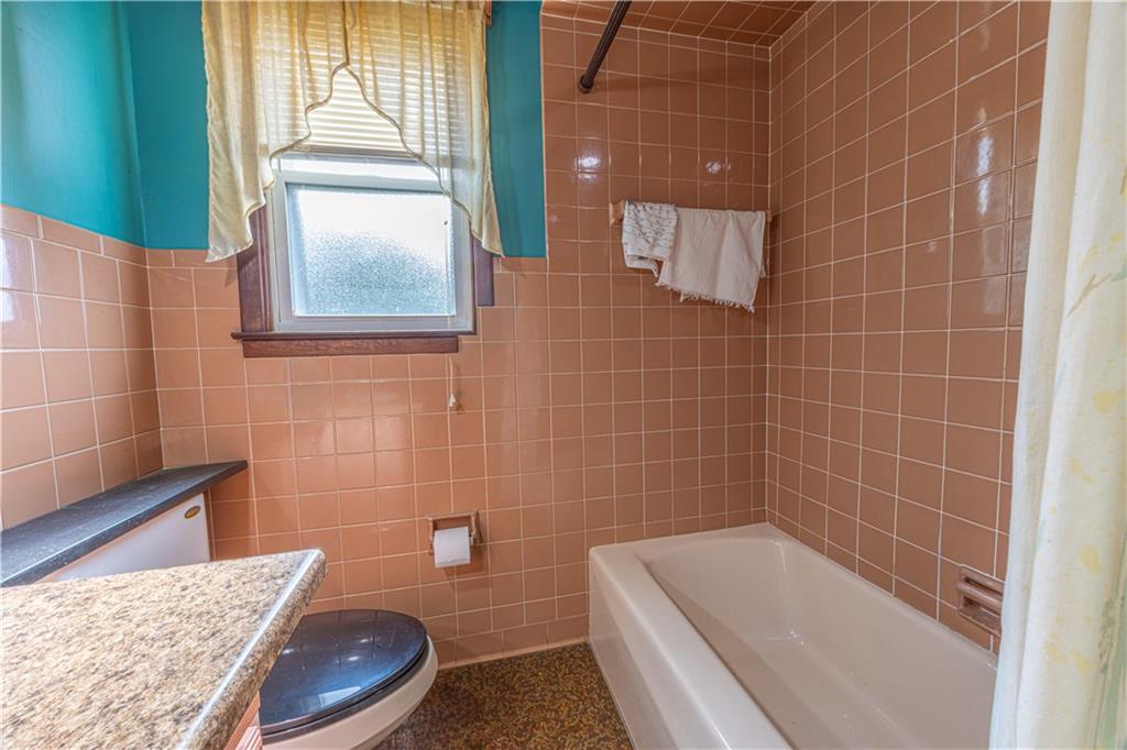 82 East Kerr Street Uniontown, PA 15401 - Photo 15 of 18 a bathroom with a tub a window and wooden floor
