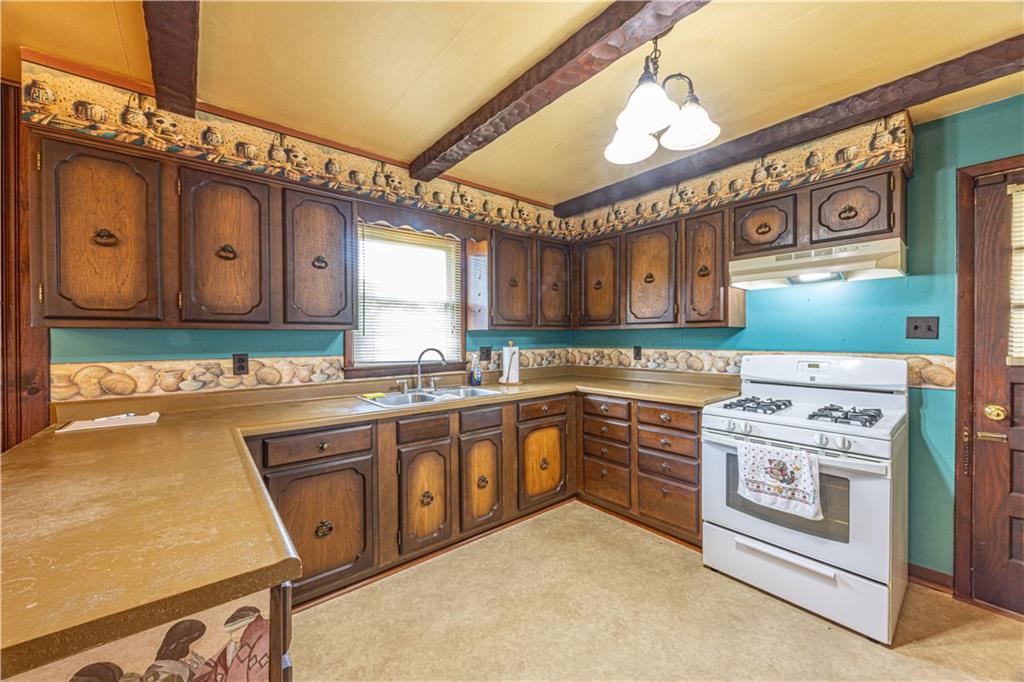 82 East Kerr Street Uniontown, PA 15401 - Photo 8 of 18 a kitchen with stainless steel appliances granite countertop a stove and a microwave