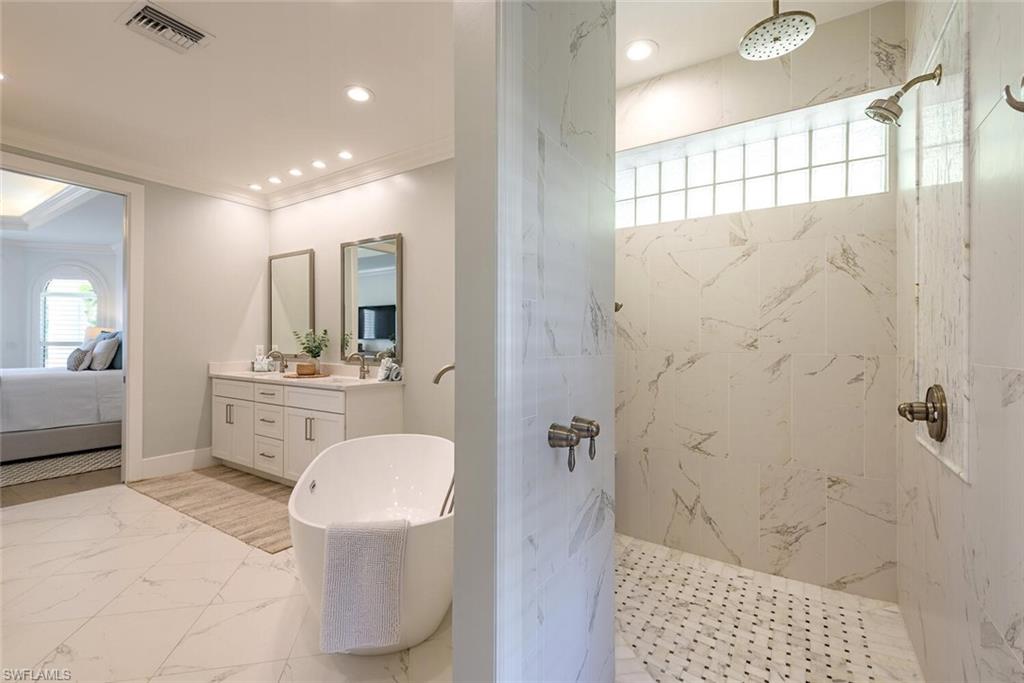 452 Willet Avenue Naples, FL 34108 - Photo 11 of 28 a bathroom with a sink a toilet and shower