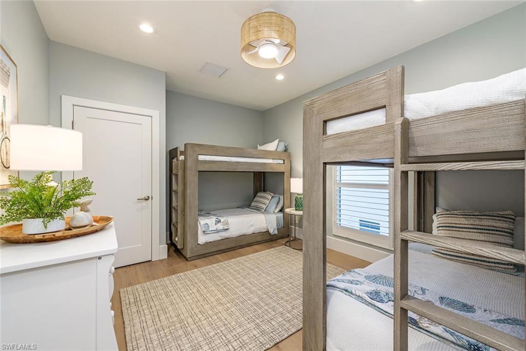 452 Willet Avenue Naples, FL 34108 - Photo 14 of 28 a bedroom with a bed and a fireplace