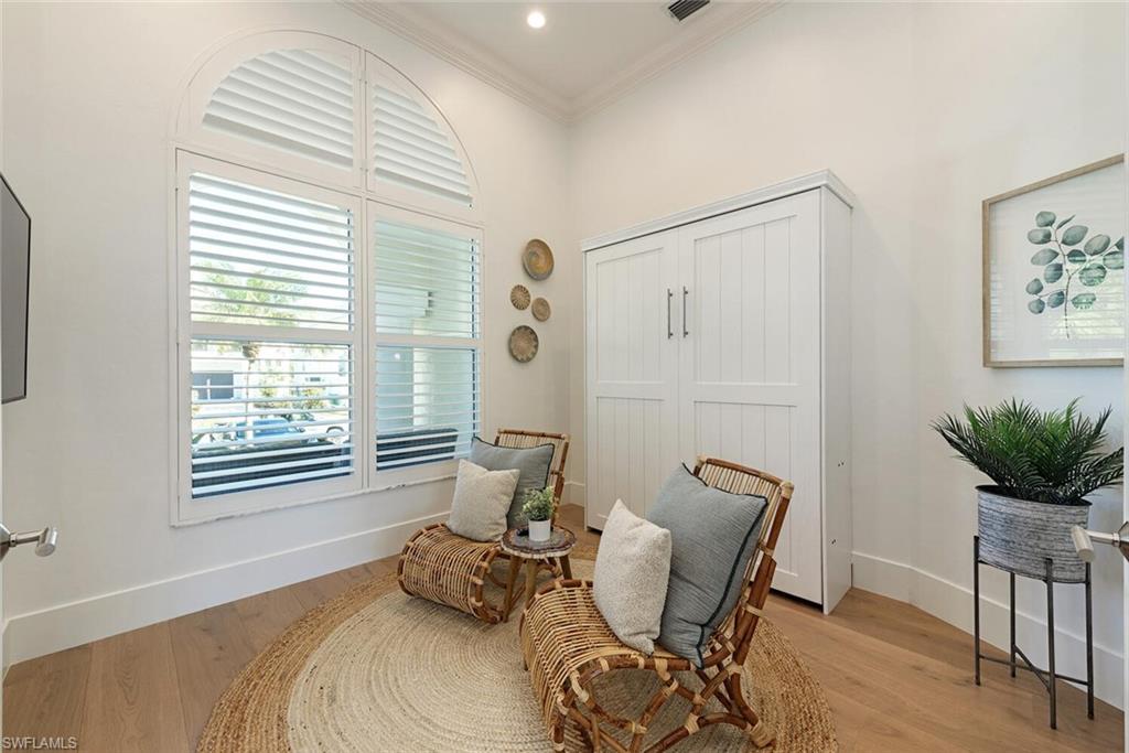 452 Willet Avenue Naples, FL 34108 - Photo 15 of 28 a bedroom with furniture and a window