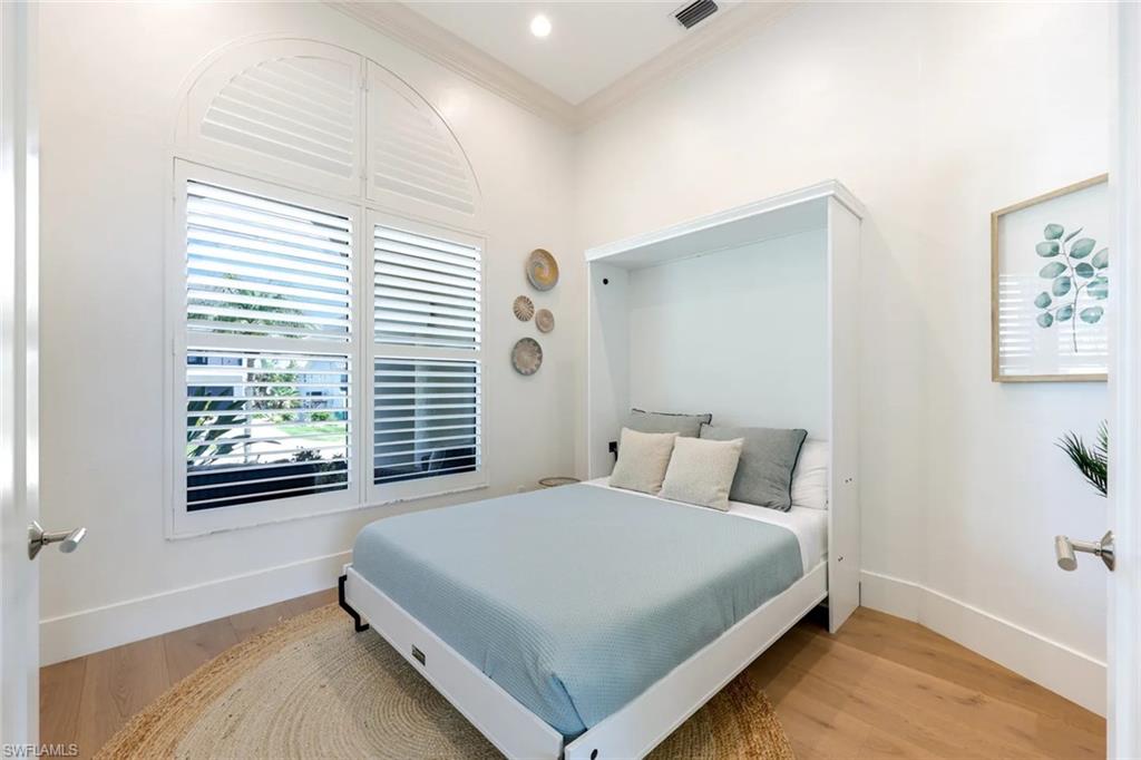452 Willet Avenue Naples, FL 34108 - Photo 16 of 28 a bedroom with a bed and a window