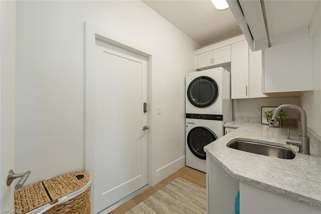 452 Willet Avenue Naples, FL 34108 - Photo 17 of 28 a utility room with sink dryer and washer