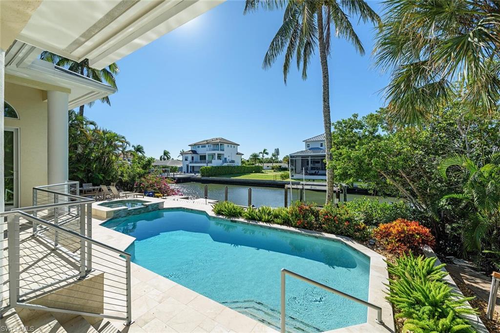 452 Willet Avenue Naples, FL 34108 - Photo 19 of 28 a view of a swimming pool with a patio
