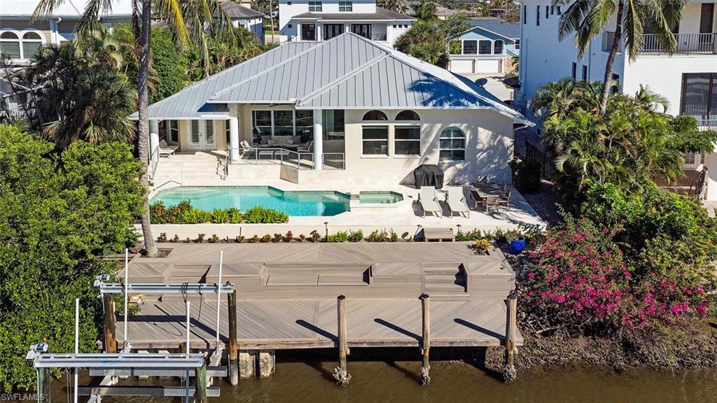 452 Willet Avenue Naples, FL 34108 - Photo 20 of 28 a aerial view of a house with a yard patio and swimming pool