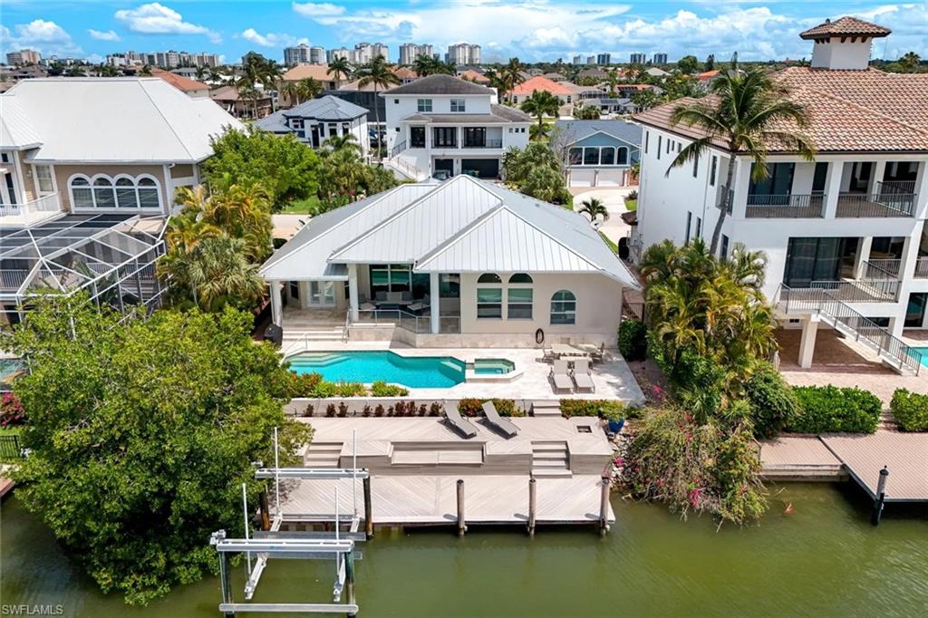 452 Willet Avenue Naples, FL 34108 - Photo 21 of 28 a aerial view of a house with swimming pool and a terrace view