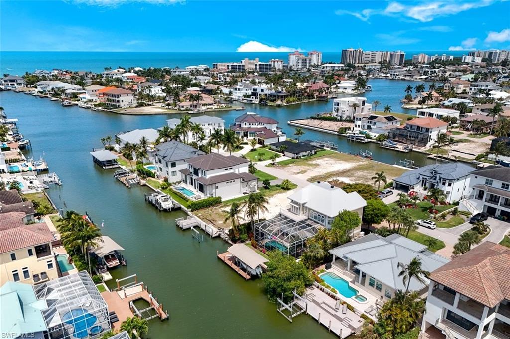 452 Willet Avenue Naples, FL 34108 - Photo 28 of 28 an aerial view of water body with boats and residential houses with outdoor space