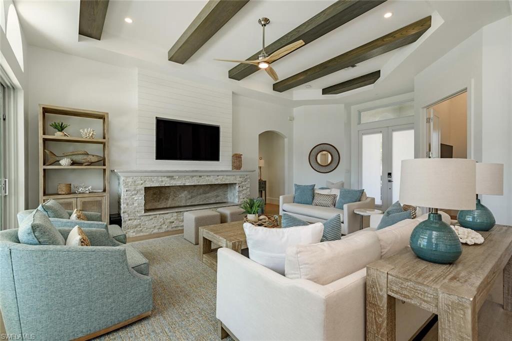 452 Willet Avenue Naples, FL 34108 - Photo 4 of 28 a living room with fireplace furniture and a flat screen tv