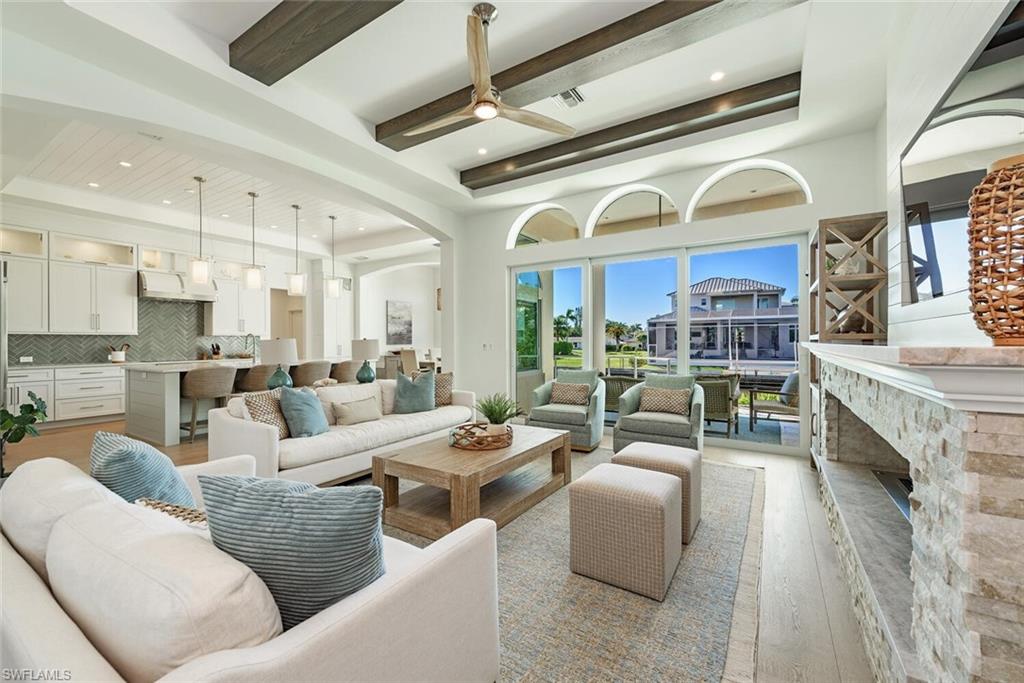 452 Willet Avenue Naples, FL 34108 - Photo 6 of 28 a living room with fireplace furniture and a large window