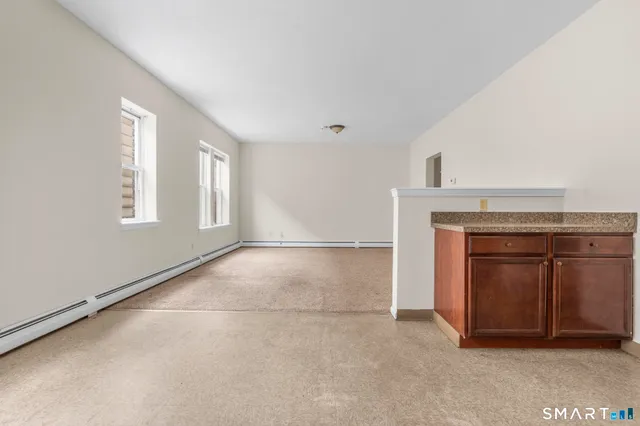 a view of a kitchen with refrigerator stove