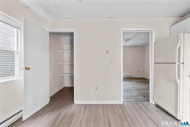 a kitchen with a refrigerator and a stove top oven